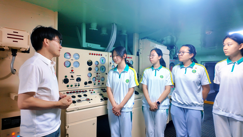 在航母舱室中,学生们聆听讲解,了解航母构造。beat365中文版官方网站供图